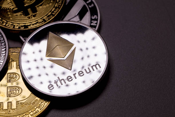 izmir, Turkey - January 12, 2026 Close up ethereum coin with other crypto coins shot in black background in studio